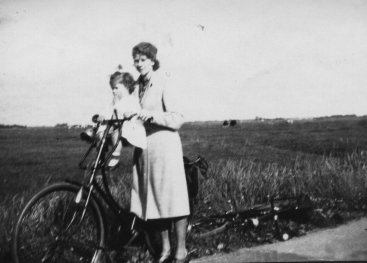 Woman with a child on her bicycle.